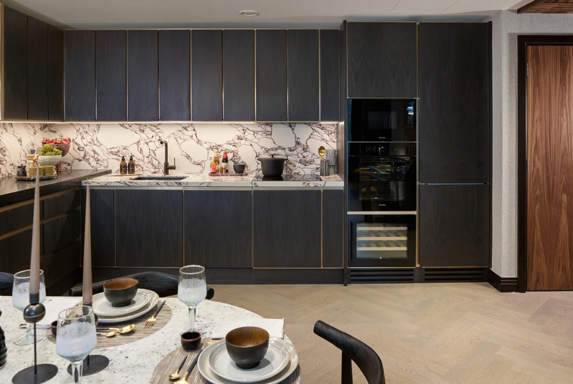 Modern open plan kitchen and dining area in a London luxury apartment with high end finishes