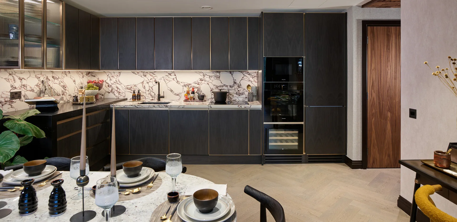Modern open plan kitchen and dining area in a London luxury apartment with high end finishes