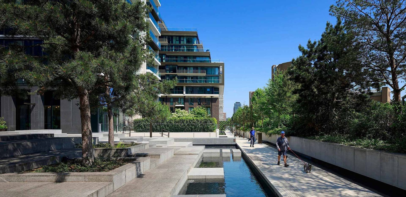 Outdoor walkway with landscaped gardens in a luxury London residential complex