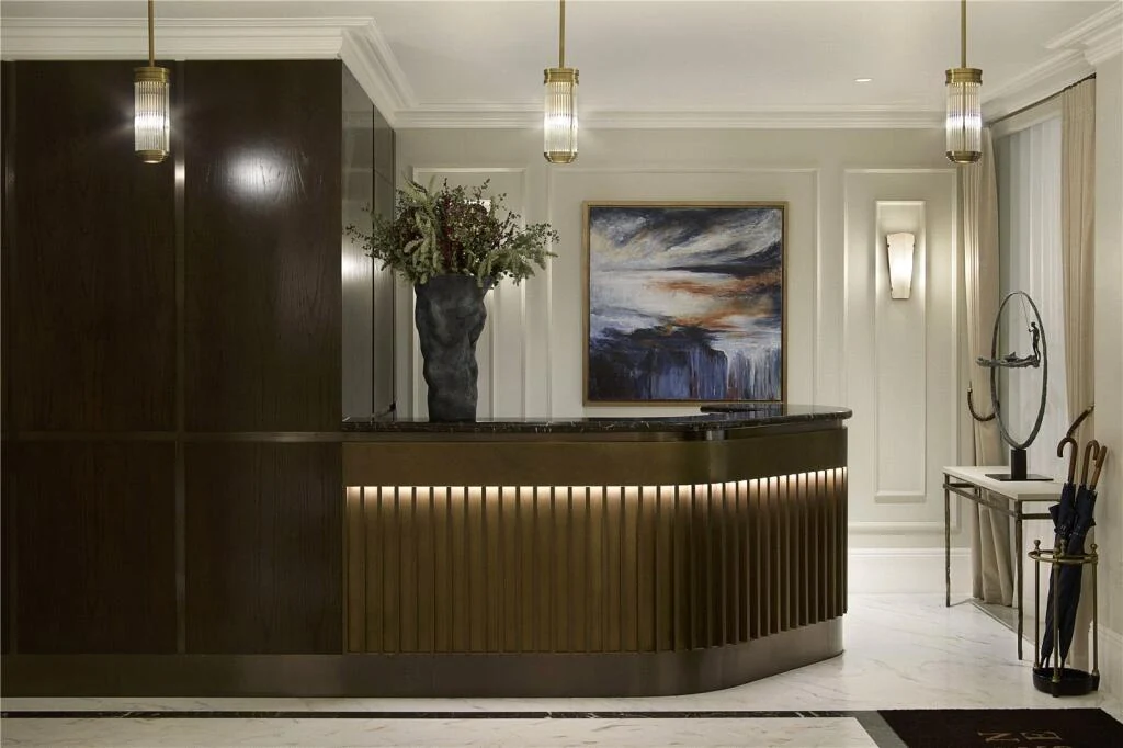 Allen House Kensington W8 24 Hour Concierge Reception Brass Pendant Lights Marble Counter Lobby