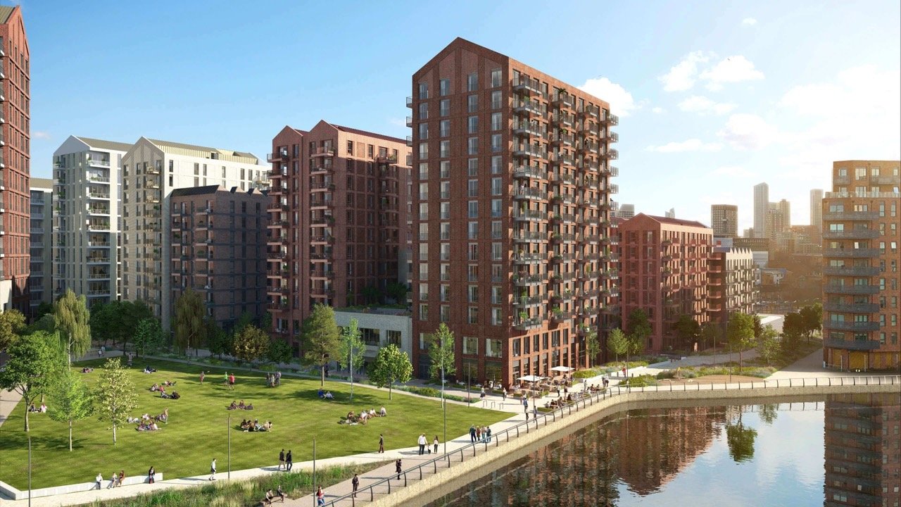 Modern riverside apartments in Canary Wharf London with park, waterfront and residential buildings in a new development