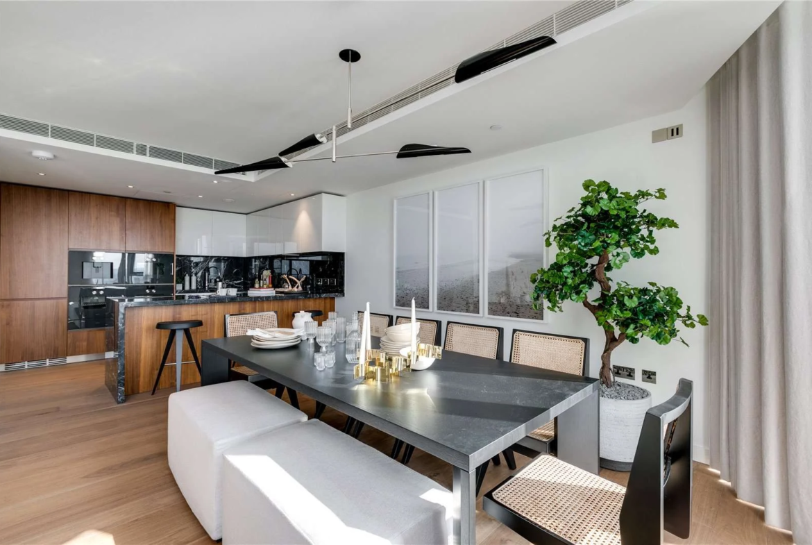 Chelsea Waterfront Tower West Sw10 Kitchen Dining Black Granite Island Walnut Cabinetry Rattan Chairs Pendant