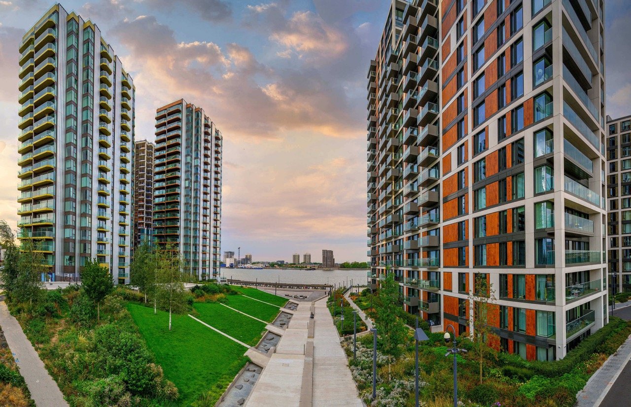 Royal Arsenal Riverside London modern apartments with Thames river views and landscaped green spaces at sunset