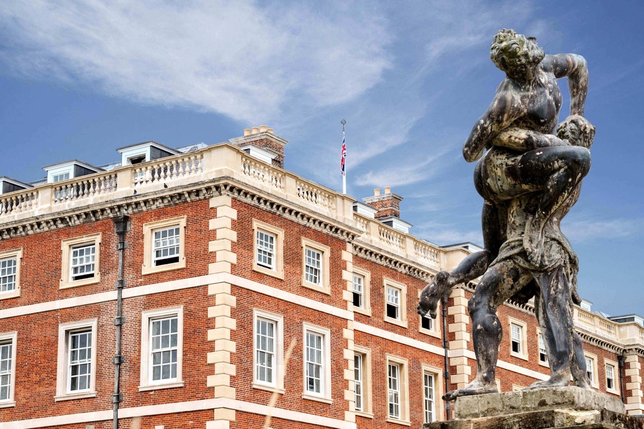 Trent Park London historic mansion building with classical statue and landscaped surroundings luxury apartments development