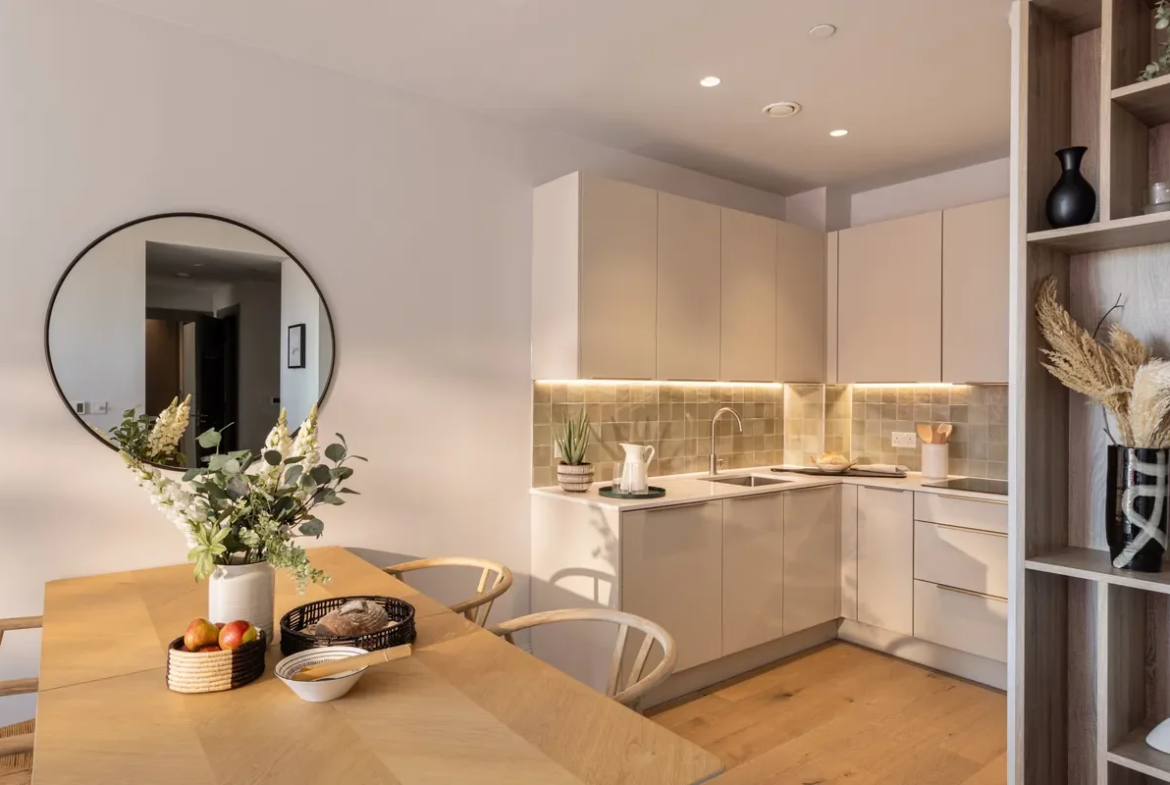 Artisi Hammersmith Town Hall London W6 2 Bed Show Home Kitchen Dining Round Mirror Oak Table Cream Cabinetry Zellige Tiles