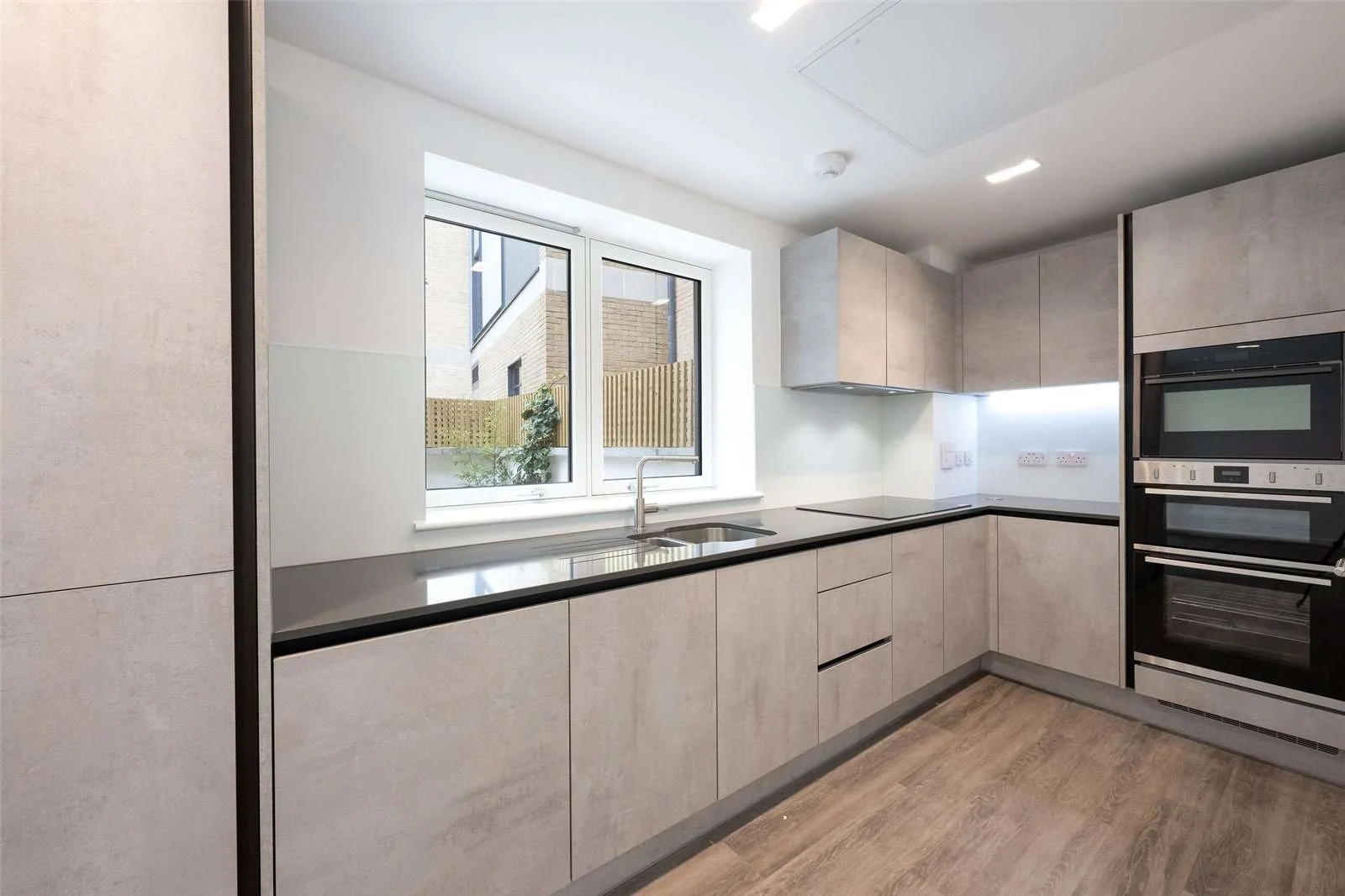 The Auria 2 Cantle Mews Portobello Square W10 Kitchen Concrete Effect Cabinets Dark Worktop Garden View
